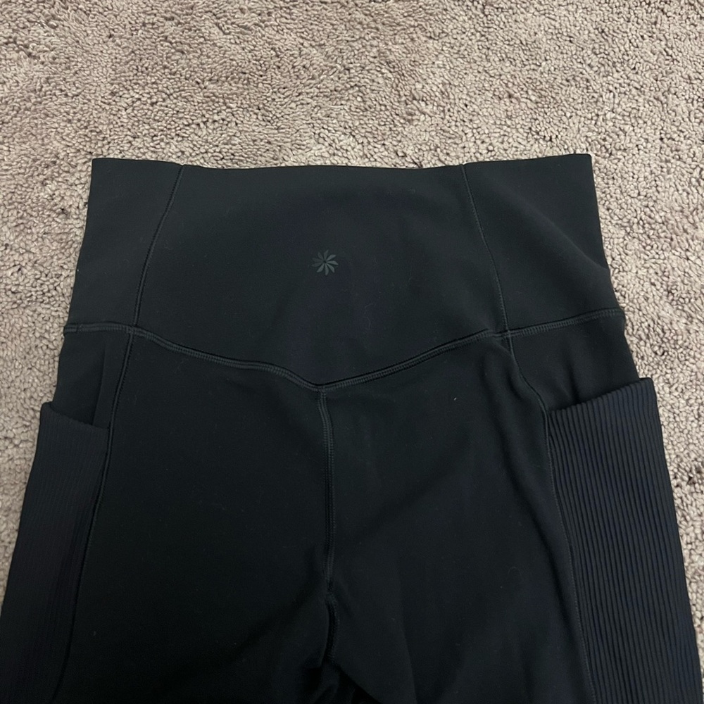 Athleta leggings. ribbed side detailings with diamond cut outs and pockets.